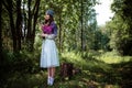 Young brunette woman walks in a summer forest park wearing stylish casual clothes Royalty Free Stock Photo