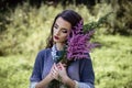 Young brunette woman walks in a summer forest park wearing stylish casual clothes Royalty Free Stock Photo