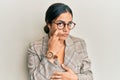 Young brunette woman wearing business jacket and glasses pointing to the eye watching you gesture, suspicious expression Royalty Free Stock Photo