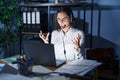 Young brunette woman wearing call center agent headset working late at night crazy and mad shouting and yelling with aggressive Royalty Free Stock Photo