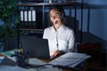 Young brunette woman wearing call center agent headset working late at night with a happy and cool smile on face Royalty Free Stock Photo