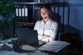 Young brunette woman wearing call center agent headset working late at night happy face smiling with crossed arms looking at the Royalty Free Stock Photo