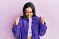 Young brunette woman wearing casual clothes excited for success with arms raised and eyes closed celebrating victory smiling Royalty Free Stock Photo