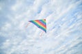 Young brunette woman, wearing casual clothes green t-shirt, playing with colorful kite on green field meadow in summer, running, Royalty Free Stock Photo