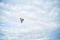 Young brunette woman, wearing casual clothes green t-shirt, playing with colorful kite on green field meadow in summer, running, Royalty Free Stock Photo