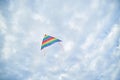 Young brunette woman, wearing casual clothes green t-shirt, playing with colorful kite on green field meadow in summer, running, Royalty Free Stock Photo