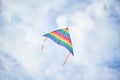 Young brunette woman, wearing casual clothes green t-shirt, playing with colorful kite on green field meadow in summer, running, Royalty Free Stock Photo