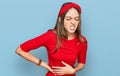 Young brunette woman wearing casual clothes suffering of backache, touching back with hand, muscular pain Royalty Free Stock Photo