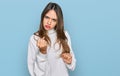 Young brunette woman wearing casual turtleneck sweater angry and mad raising fist frustrated and furious while shouting with anger Royalty Free Stock Photo