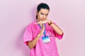 Young brunette woman wearing doctor uniform and stethoscope doing time out gesture with hands, frustrated and serious face