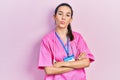 Young brunette woman wearing doctor uniform and stethoscope standing with arms crossed looking at the camera blowing a kiss being Royalty Free Stock Photo