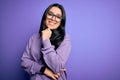 Young brunette woman wearing glasses over purple isolated background looking confident at the camera smiling with crossed arms and Royalty Free Stock Photo