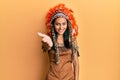 Young brunette woman wearing indian costume smiling friendly offering handshake as greeting and welcoming Royalty Free Stock Photo