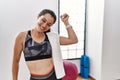 Young brunette woman wearing sportswear and towel at the gym dancing happy and cheerful, smiling moving casual and confident Royalty Free Stock Photo