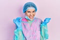 Young brunette woman wearing surgeon uniform holding tweezers screaming proud, celebrating victory and success very excited with