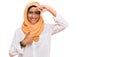 Young brunette woman wearing traditional islamic hijab scarf smiling making frame with hands and fingers with happy face Royalty Free Stock Photo