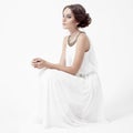 Young brunette woman in white dress. White Background. Royalty Free Stock Photo
