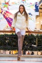 Young brunette woman in white fur coat and high suede boots Royalty Free Stock Photo