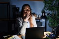 Young brunette woman working at the office at night bored yawning tired covering mouth with hand Royalty Free Stock Photo