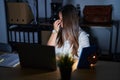 Young brunette woman working at the office at night tired rubbing nose and eyes feeling fatigue and headache Royalty Free Stock Photo