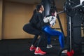 Young brunette woman working out legs with barbell in gym. personal female trainer. Squat Exercise Royalty Free Stock Photo