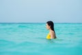 Young brunette woman in yellow one piece swimsuit. Royalty Free Stock Photo