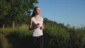 Young brunnete sporty woman running in the park. She listening to the music.