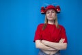 Young brutal girl fan is standing confidently on a blue background