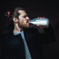 Young brutal sailor drinking a bottle of milk. Creative Portrait Royalty Free Stock Photo