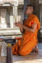 Young praying Buddhist monk in Angkor Wat, Cambodia