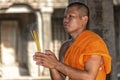 Young praying Buddhist monk in Angkor Wat, Cambodia