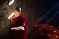 Young Buddhist monk reading