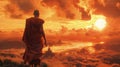 A young Buddhist monk watches a beautiful orange sunset Royalty Free Stock Photo