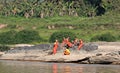 Young Buddhist Monks Sit Along the Mekong River, Laos Royalty Free Stock Photo