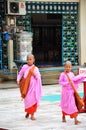 Young Buddhist woman ascetic or nun walking go to study at Botahtaung Pagoda