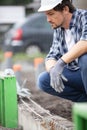 young builder laying foundation base