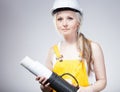 Young builder woman construction worker, blueprints plan Royalty Free Stock Photo