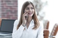 Young buisnes woman talking on a mobile phone.