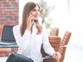 Young buisnes woman talking on a mobile phone.