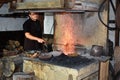 Young Bulgarian craftsperson coppersmith working in smithy Royalty Free Stock Photo