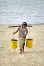 Burmese woman carrying water