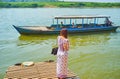 The young Burmese woman weits the ferry to Ava