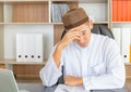 Young business arab middle eastern muslim casual serious man sitting head in hands at the office