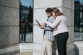 Young business associates collaborating on a project in a downtown city area Royalty Free Stock Photo