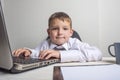 Young business boy is working in the office. A child disguised as a businessman. Funny kids Royalty Free Stock Photo