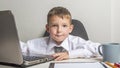 Young business boy is working in the office. A child disguised as a businessman. Funny kids Royalty Free Stock Photo