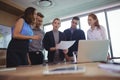 Young business colleagues discussing in metting room Royalty Free Stock Photo