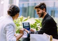 Young business couple meeting with tech devices