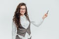 Young business lady with beautiful curly hair on a white background. During this, the marker holds in his hands, showing Royalty Free Stock Photo