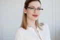 Young business lady in white shirt and glasses. Attractive young woman smiling Royalty Free Stock Photo